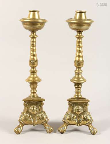 A PAIR OF 17TH CENTURY BRASS CANDLESTICKS on triangular base...