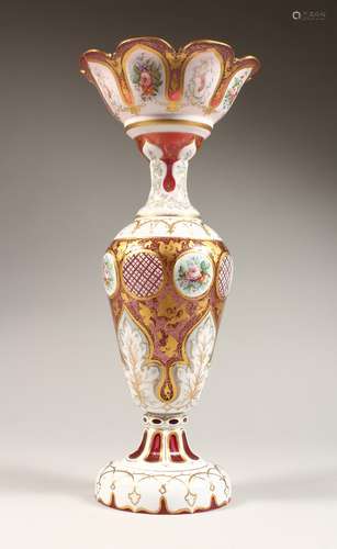 A TALL BOHEMIAN WHITE OVERLAY RED VASE with decoration paint...