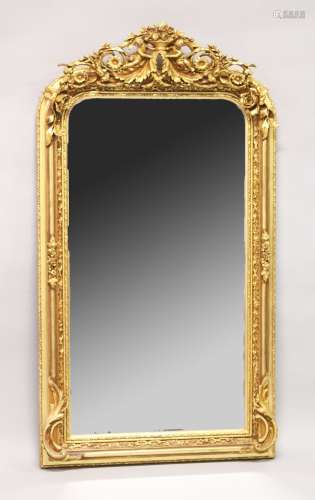 A LARGE ORNATE GILT FRAMED ARCH TOP MIRROR, the top with che...