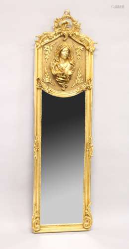 A TALL NARROW GILT FRAMED MIRROR, the upper panel decorated ...