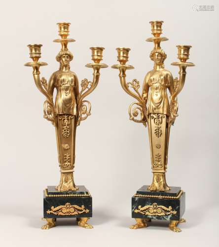 A PAIR OF GILT, BRONZE AND MARBLE THREE LIGHT FIGURAL CANDEL...
