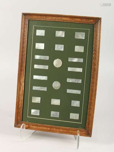 TWENTY TWO ENGRAVED MOTHER OF PEARL COUNTERS in a frame. 12i...