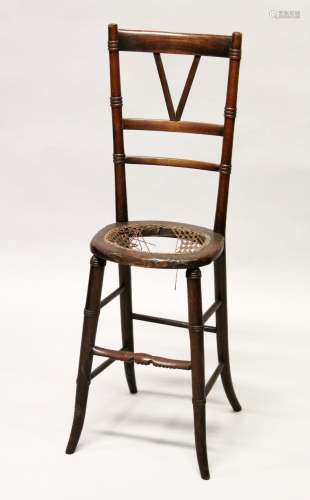 A 19TH CENTURY CHILD'S BEECH CORRECTION CHAIR 3ft 2ins high.