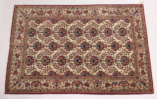 A GOOD PERSIAN KAHAN CARPET, cream ground with vases of flow...