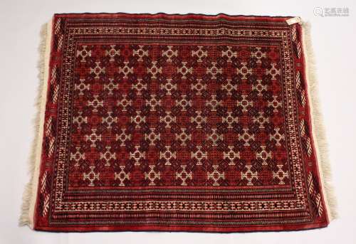 A TURKOMEN YAMUD CARPET, red ground with all over geometric ...