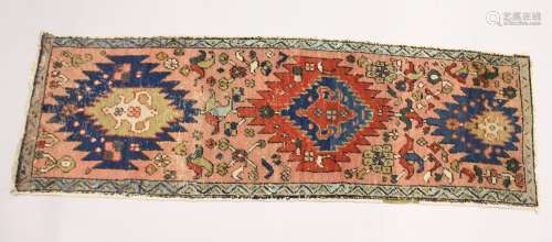 A SMALL HERIZ RUNNER, pink ground with three medallions 5ft ...