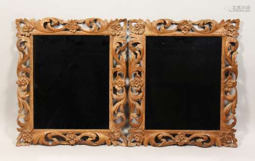 A PAIR OF 19TH CENTURY MIRRORS with leaf and flower carved w...