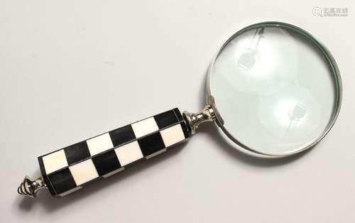 A MAGNIFYING GLASS with chequered handle