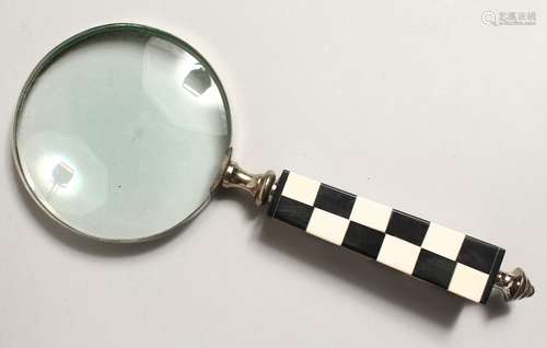 A MAGNIFYING GLASS with chequered handle