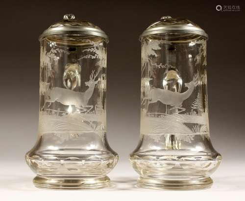 A PAIR OF ENGRAVED GLASS BEER JUGS with pewter trim, deer in...