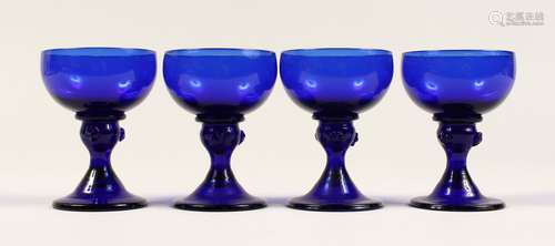 A SET OF FOUR BRISTOL BLUE GLASSES 3.5ins high.