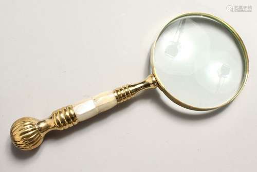 A MAGNIFYING GLASS with mother of pearl and gilt handle