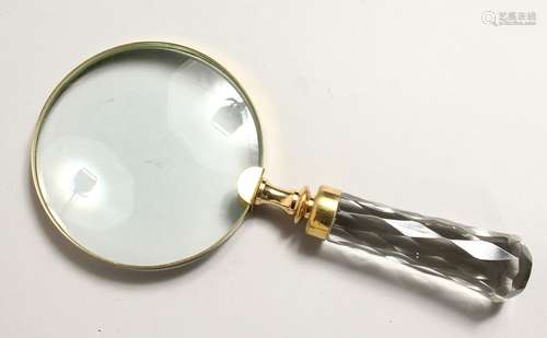 A MAGNIFYING GLASS with cut glass handle