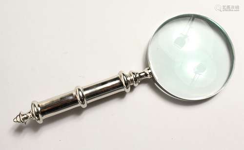 A MAGNIFYING GLASS with chrome handle