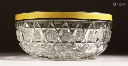 A CUT GLASS CIRCULAR BOWL with silver and yellow enamel rim ...