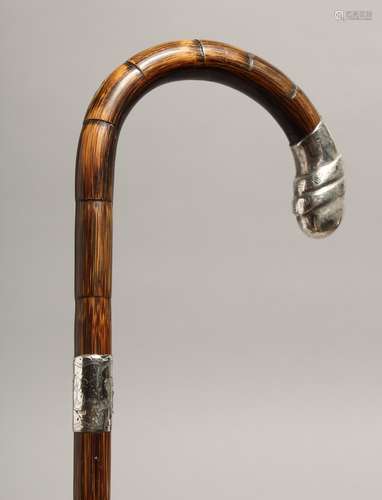 A WALKING STICK with silver handle. London 1929, 35ins long