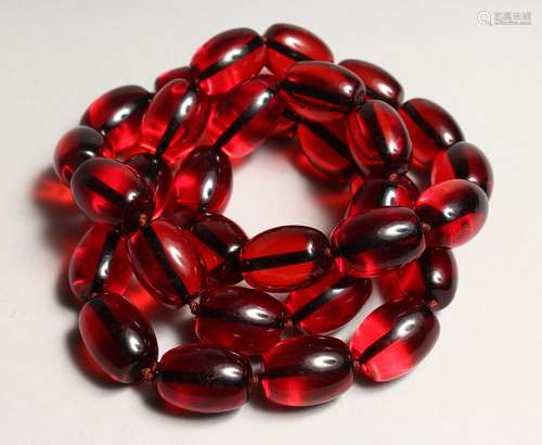 A STRING OF CHERRY AMBER BEADS