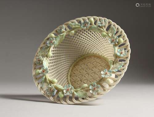 A BELLEEK PORCELAIN CIRCULAR PIERCED BASKET, the rim decorat...