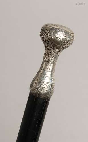 A WALKING CANE with SILVER HANDLE Engraved `POUR COMBLE DE B...