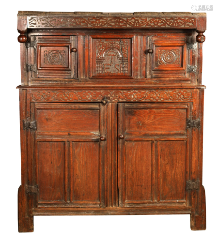 A 17TH CENTURY CARVED OAK DUDARN/COURT CUPBOARD OF