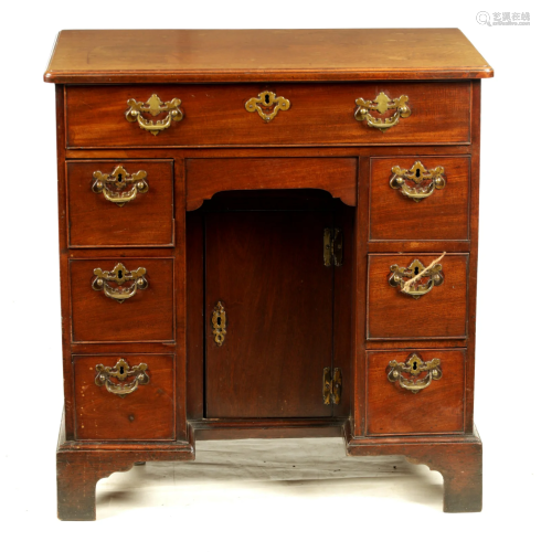 A GEORGE III MAHOGANY KNEEHOLE DESK with rounded