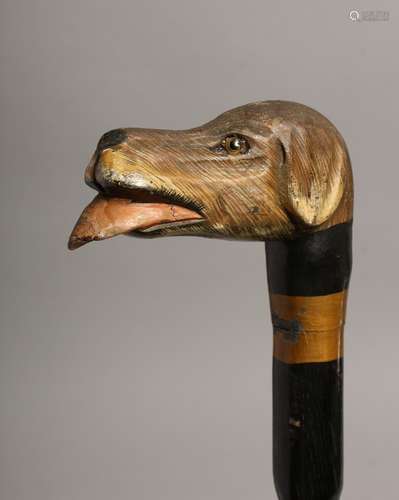 A WALKING STICK with carved wood dog's head 38ins long.