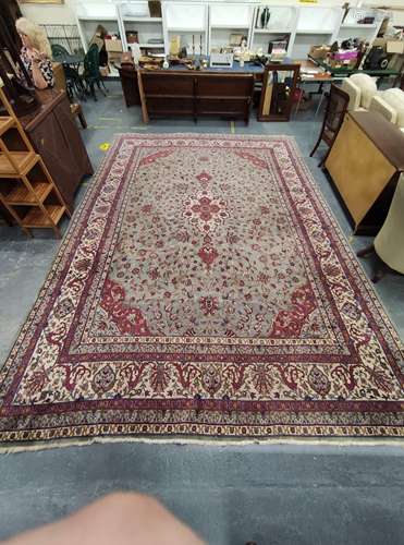 Indian Carpet decorated with a large floral medallion to the...