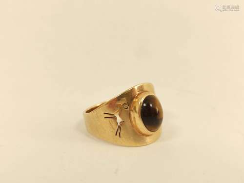 Gold ring with tigers eye cabochon and pierced gazelle shoul...