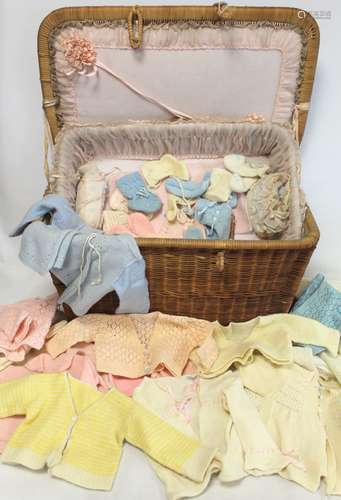 Vintage wicker layette basket lined in pink gauze with ribbo...