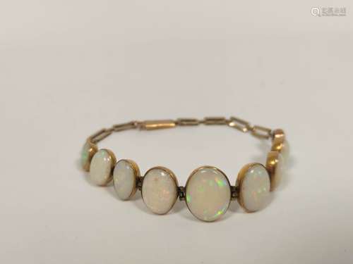 Opal bracelet with nine, collet set, the largest 14mm in gol...