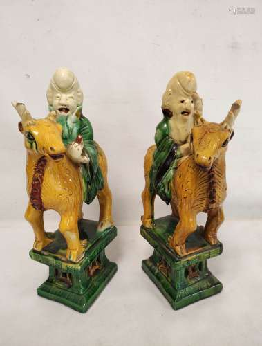 Mirror pair of Chinese pottery statues in the sancai palette...