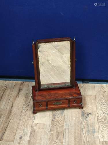 Georgian mahogany dressing glass, the swing mirror above a c...