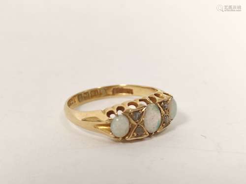 18ct gold ring with three opals and diamond points, 1914. Si...