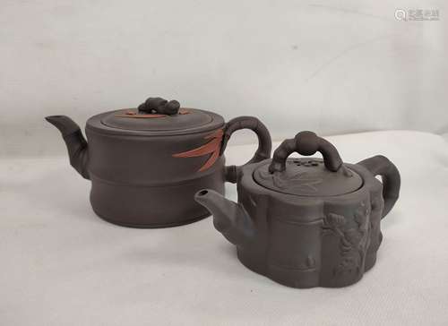 Two Chinese Yixing black clay teapots, one of cylindrical fo...