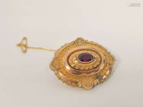 Victorian gold mourning brooch with oval garnet.