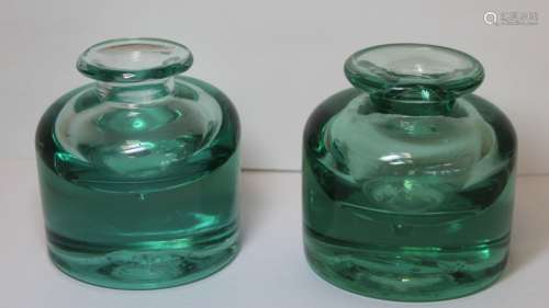 Two 19th century heavy green glass inkwells of cylindrical f...
