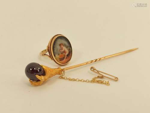 Victorian gold scarf pin with birds claw grasping a garnet b...