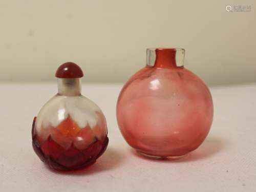 Two Chinese red glass snuff bottles, one of spherical form w...