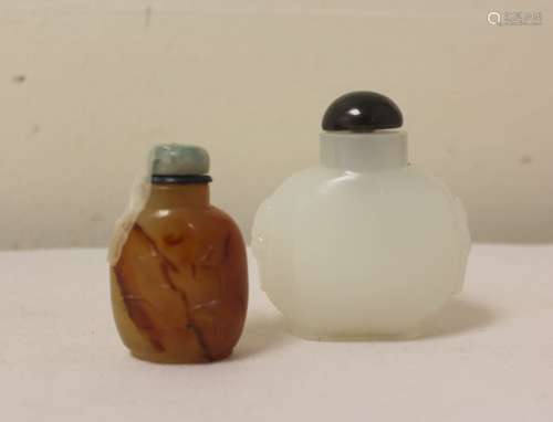 Two Chinese snuff bottles, one in white glass of bulbous for...