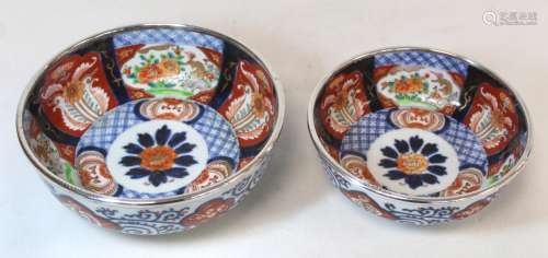 Graduated pair of Japanese Imari bowls with panels of flower...