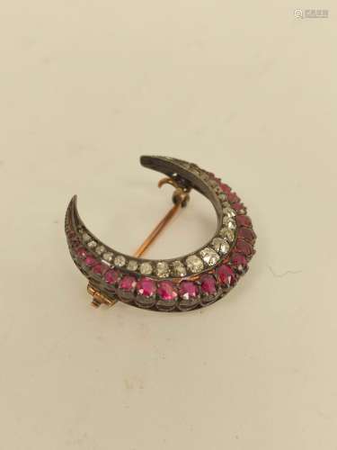 Victorian crescent brooch with graduated old cut rubies and ...