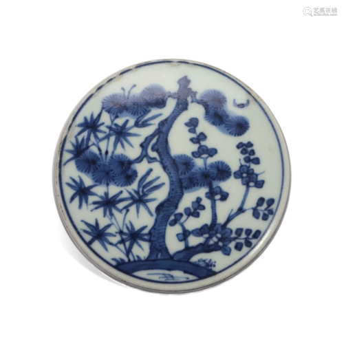 A BLUE AND WHITE CIRCULAR PAPERWEIGHT