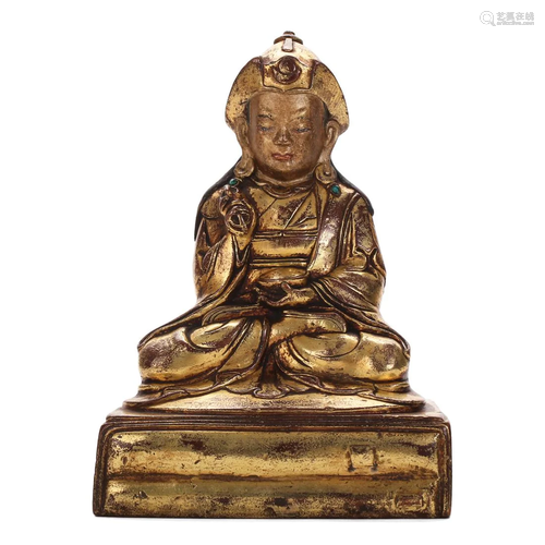 A GILT-BRONZE FIGURE OF A LAMA