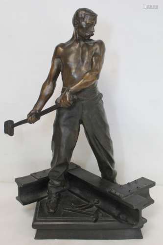 French patinated bronze sculpture of a metal worker riveting...
