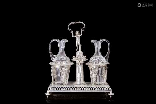 A silver oil and vinagre holder, a wine cooler and bottles w...