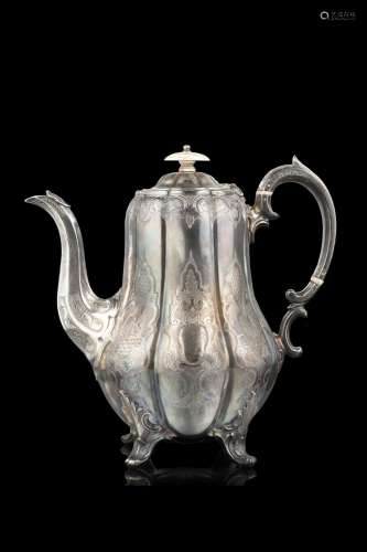 A silver teapot decorated with an arabesque pattern, ivory g...