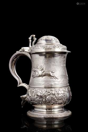 Embossed silver tankard decorated with equestrian motifs. In...