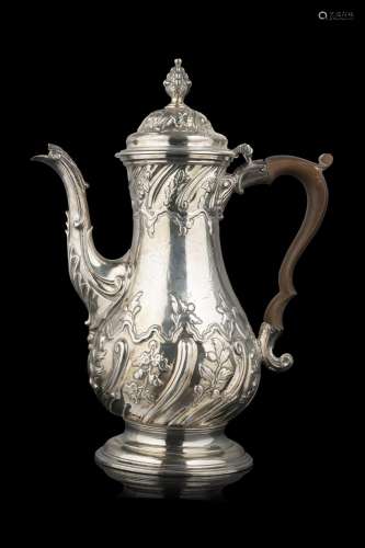 An embossed silver coffee pot engraved with floral motifs. W...