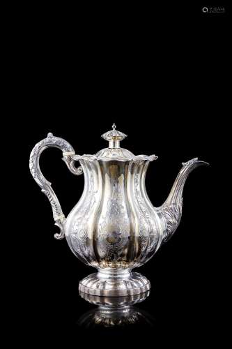 A silver teapot decorated with swirls and spirals. London, 1...