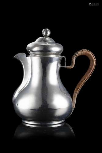 A silver coffe pot with wicker covered handle. Venice, first...